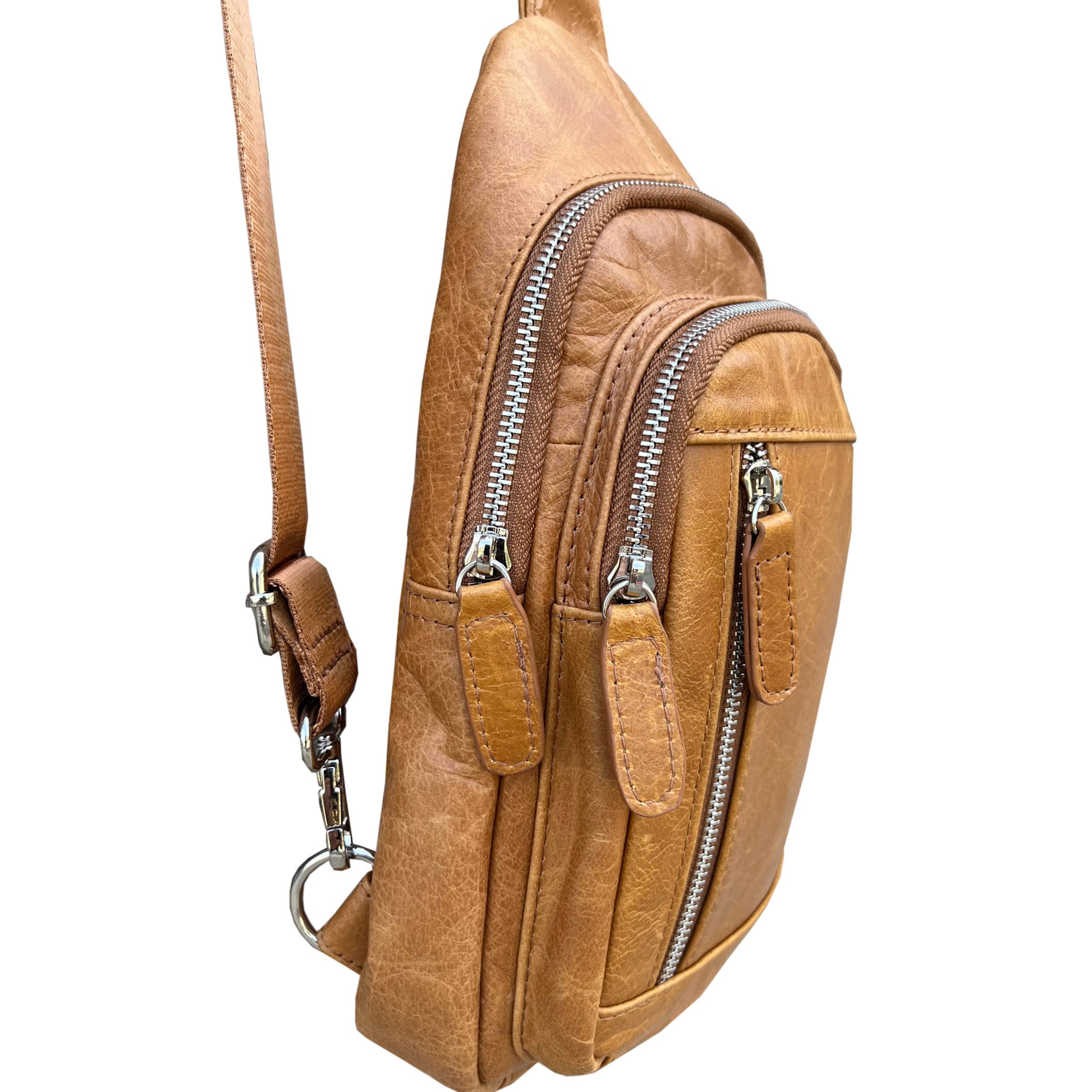 Image of Brown leather crossbody bag with zippers on a white background