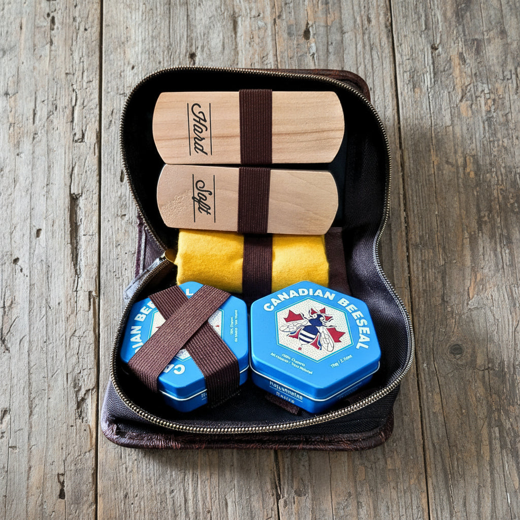 Image of Canadian Beeswax products including wooden bars, yellow cloths, and blue tins in a black zippered case.