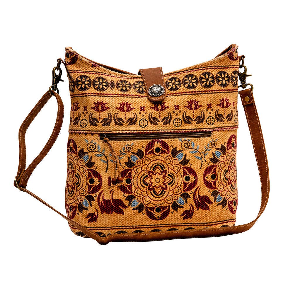 Image of Brown handbag with intricate patterns on a white background