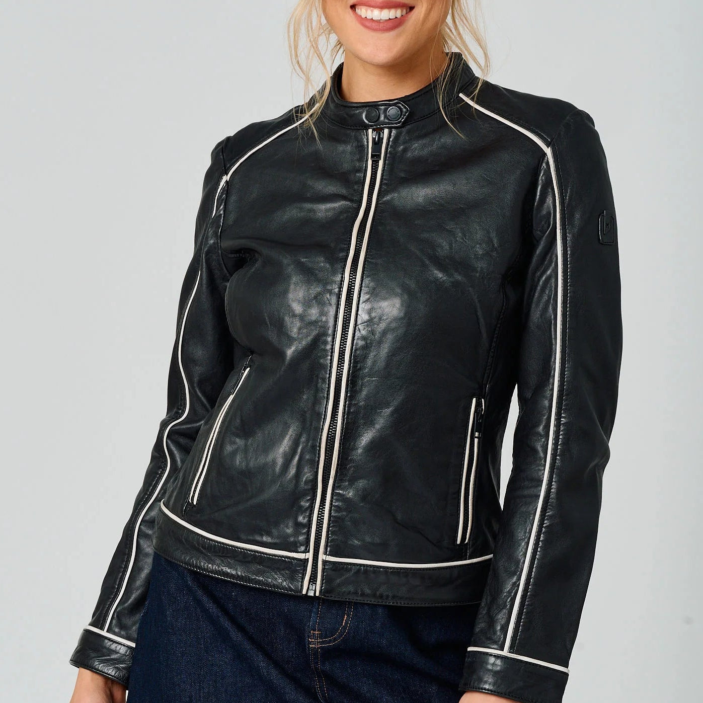 Image of Black leather jacket with contrast trim, zip front, and a fitted silhouette for a polished moto inspired look.