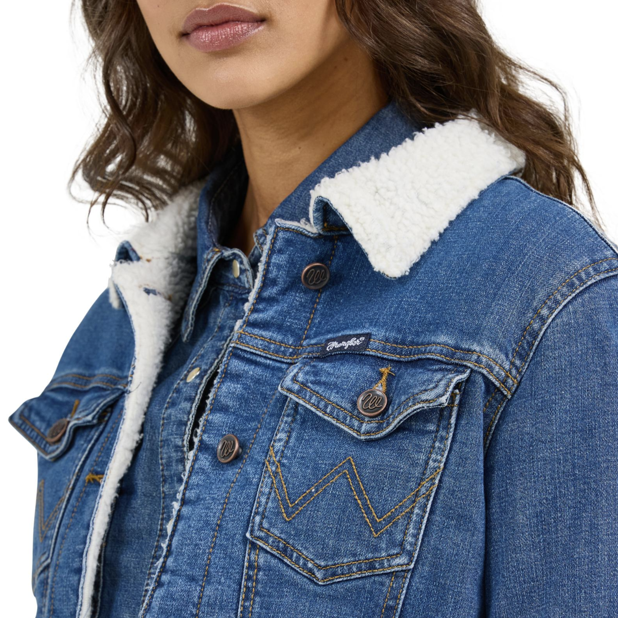Image of Blue denim jacket with white sherpa lining worn by a person