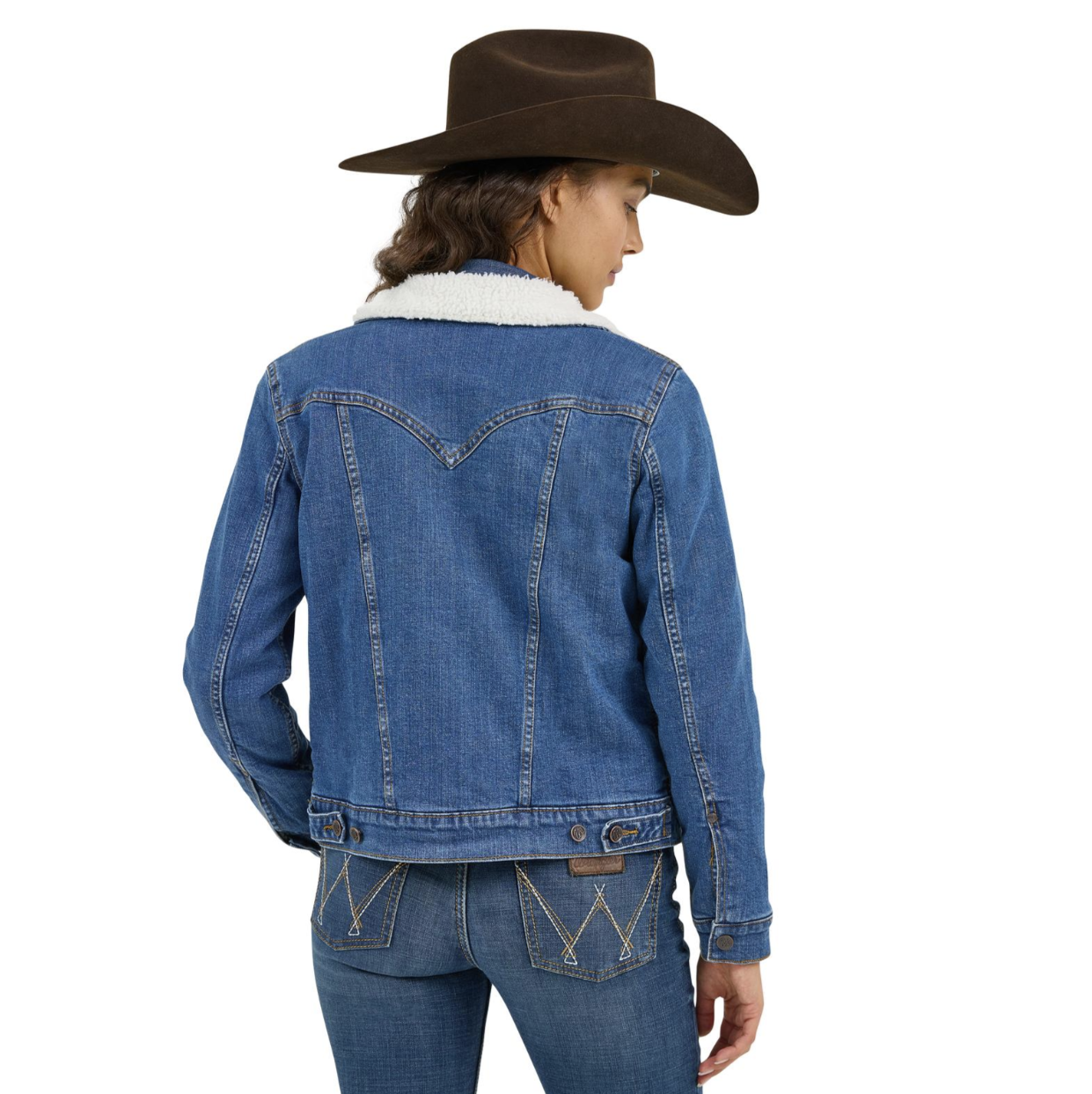 Image of Person wearing a blue denim jacket and brown cowboy hat on a white background