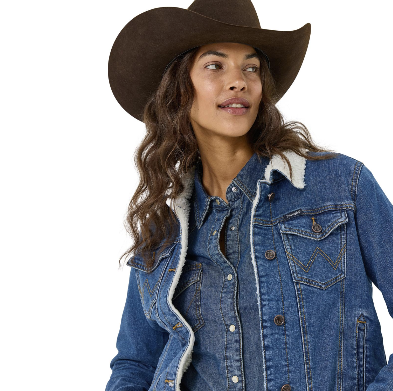 Image of Woman wearing a blue denim jacket with white fur lining and a brown cowboy hat on a white background