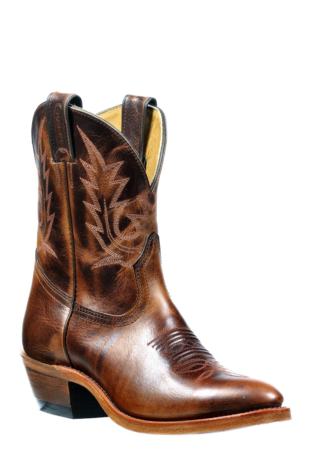 Image of Brown cowboy boot with intricate leatherwork on a white background
