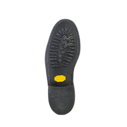 Image of Black shoe sole with a yellow dot on a white background