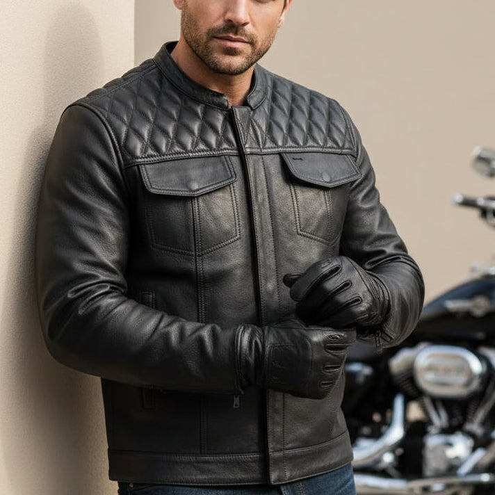 Image of Black leather jacket with quilted shoulder design on a white background