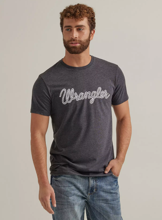 Image of Man wearing a dark gray 'Wrangler' t-shirt against a plain background