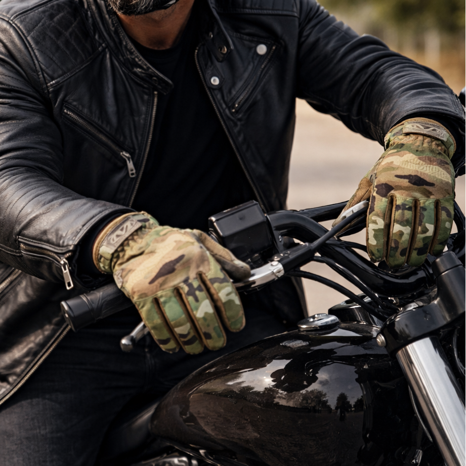 Image of Man riding a motorcycle wearing a black helmet, leather jacket, and gloves.