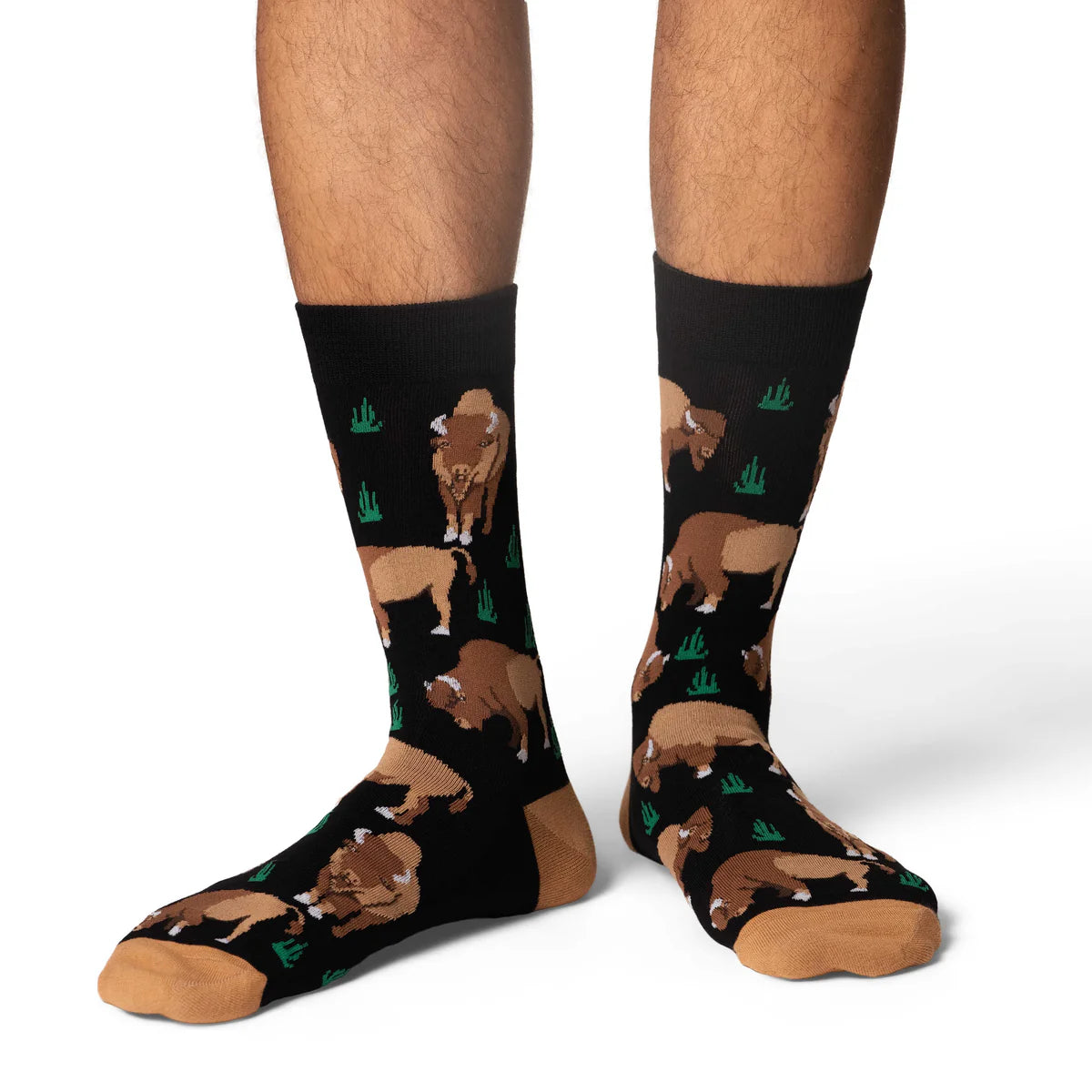 Image of Men’s black crew socks with a bison pattern, shown worn for a rugged western inspired look.