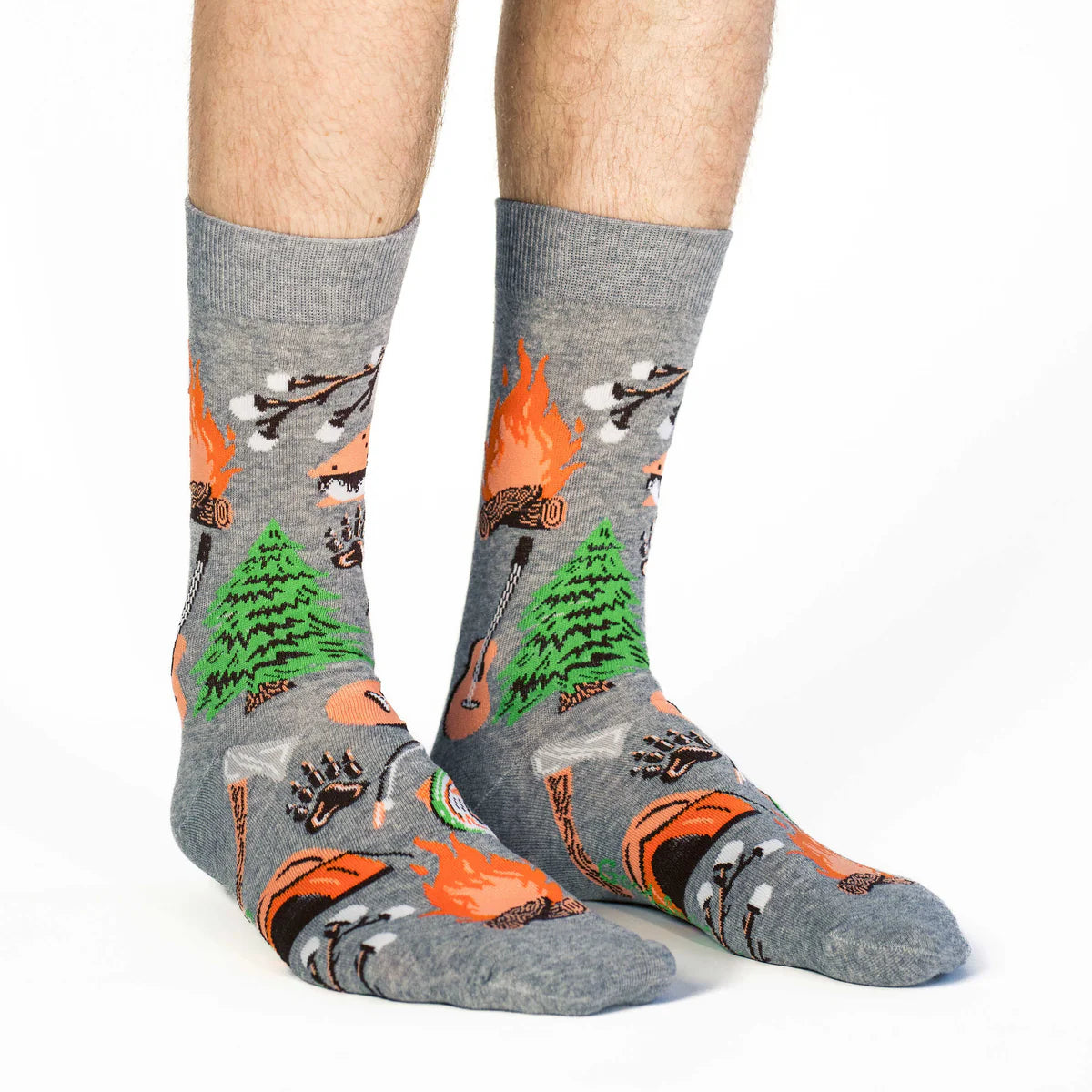 Image of Men’s heather grey crew socks with a playful camping pattern, shown worn for a fun outdoor inspired look.