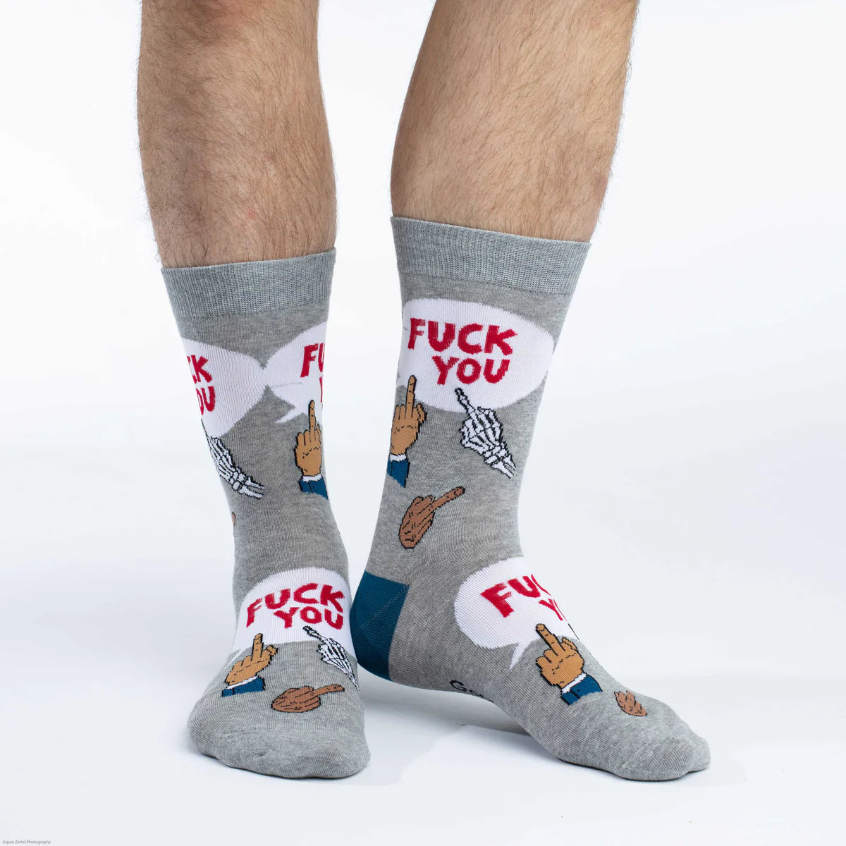 Image of Men’s grey socks with a bold humorous pattern, shown worn for an unapologetic statement look.