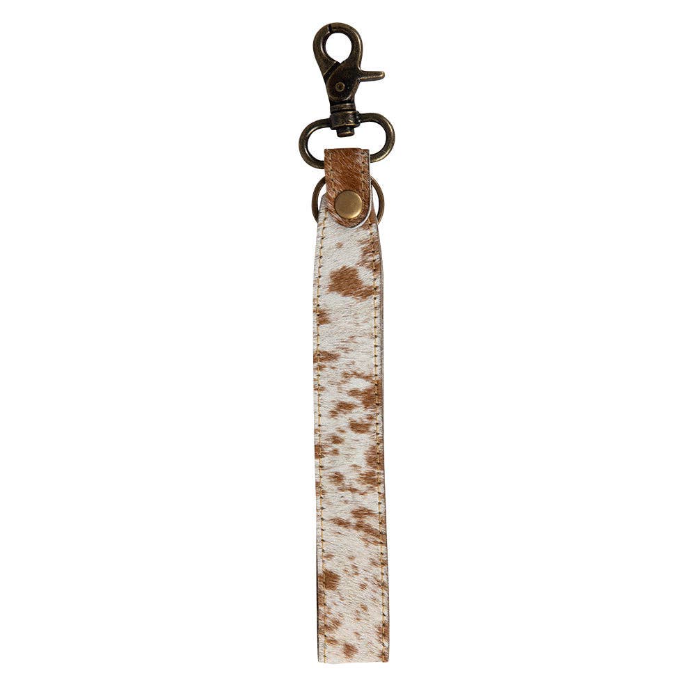 Image of Cow print leather keychain with metal clasp on a white background