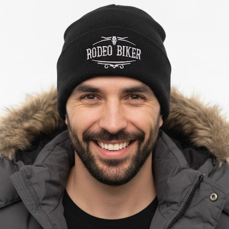 Image of Man wearing a black beanie with 'Rodeo Biker' text and a gray jacket on a white background