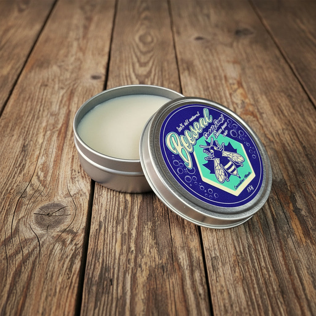 Image of Open tin of beeswax with a decorative label on a white background