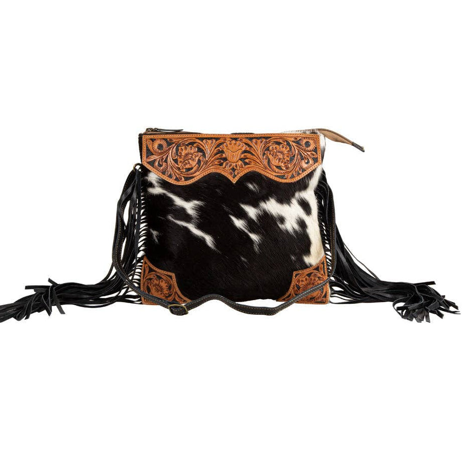 Image of Cowhide bag with leather accents and fringes on a white background