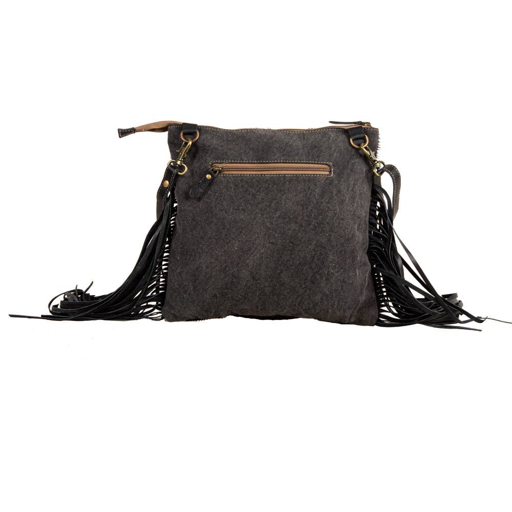 Image of Gray handbag with black fringes on a white background