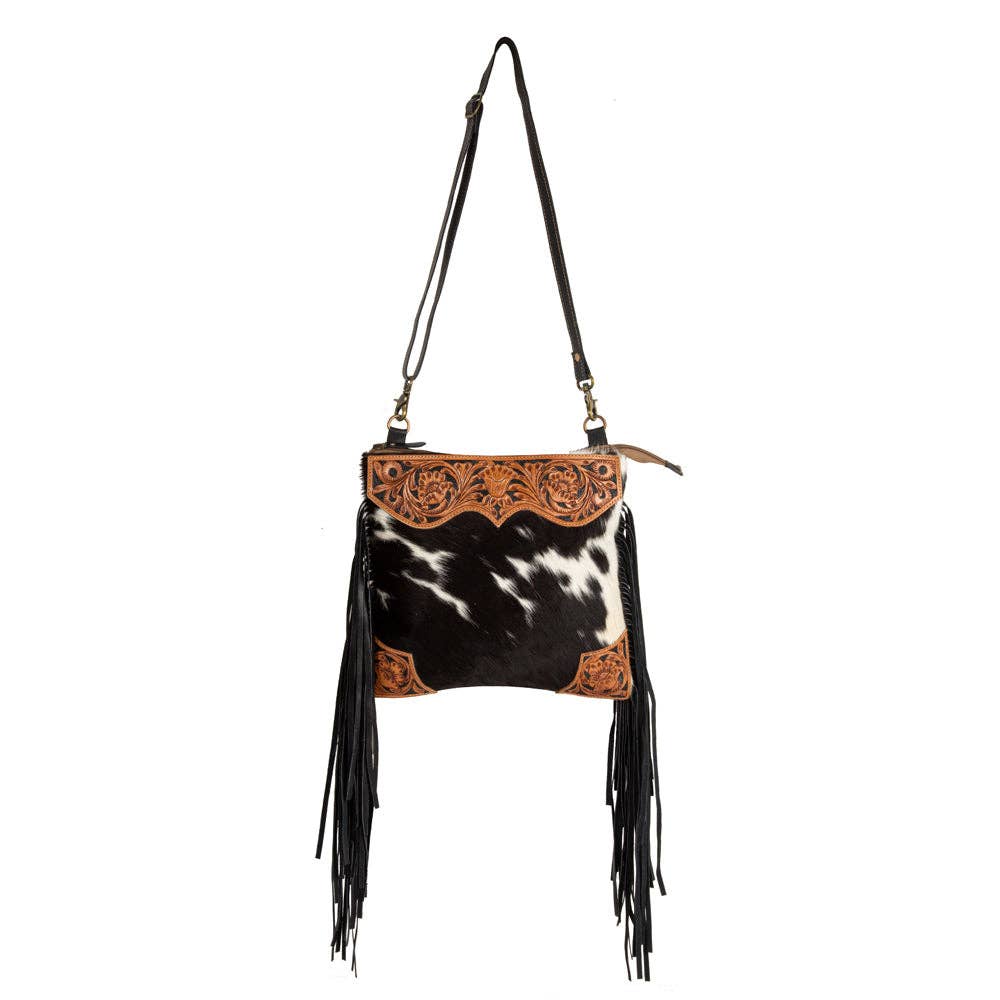 Image of Cowhide leather handbag with fringe and decorative cut-out panel on a white background