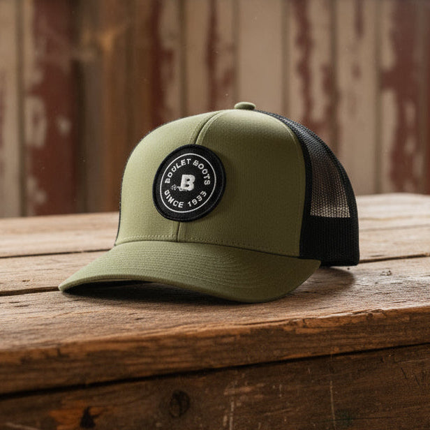 Image of Green trucker cap with black mesh and logo on a white background