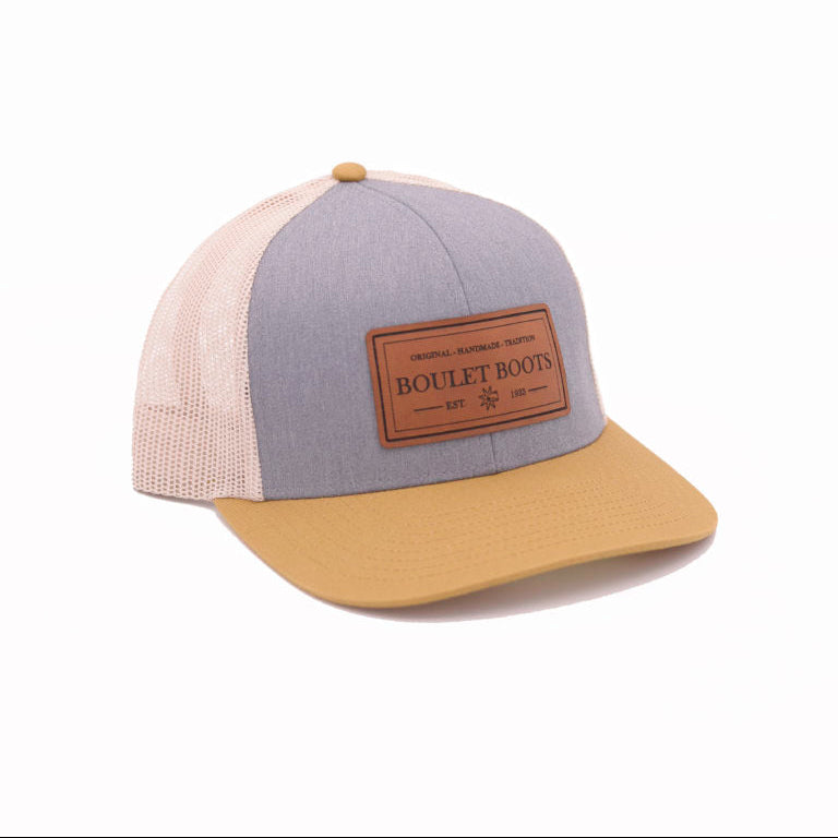 Image of Gray and green cap with a brown patch on a white background