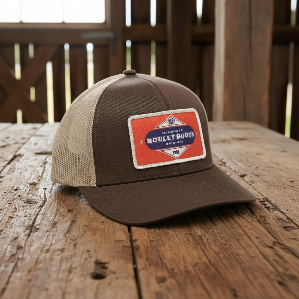 Image of Brown and beige cap with a visible brand logo on a white background