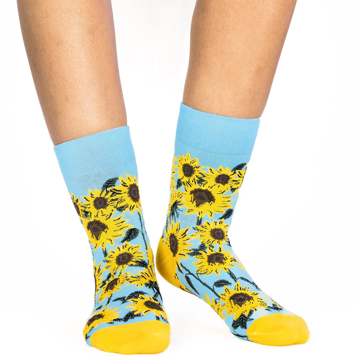 Image of Women’s sky blue socks with a bright sunflower pattern, shown worn for a cheerful floral inspired look.