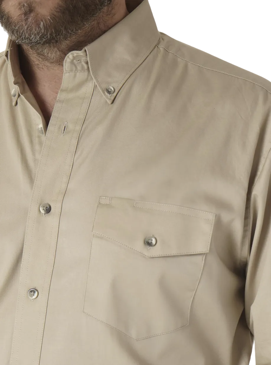Image of Close-up of a man wearing a beige long-sleeve button-down shirt with a chest pocket and silver snap buttons.