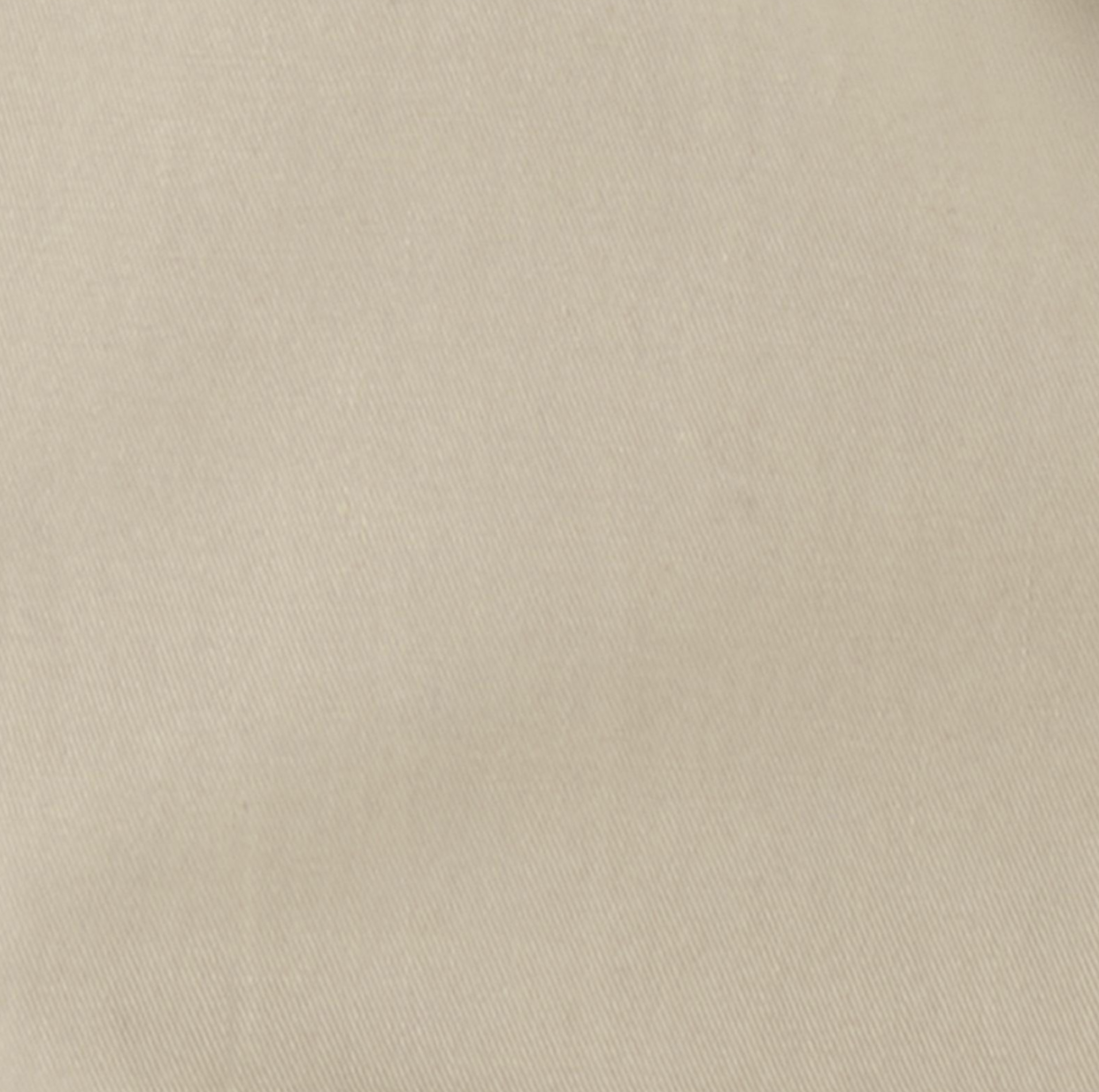 Image of A close-up of a light beige fabric texture with a fine woven pattern.