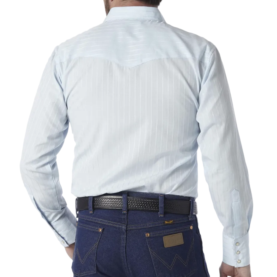 Image of A man viewed from behind wearing a light blue and white striped western shirt, a black cowboy hat, and dark blue jeans against a light gray background.