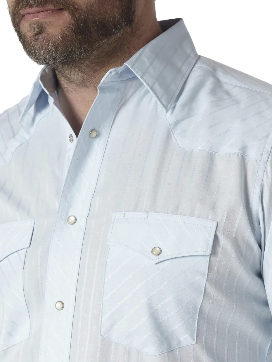 Image of Close-up of a man wearing a light blue western-style button-down shirt with a subtle diagonal textured pattern, featuring a pointed collar and a chest pocket.