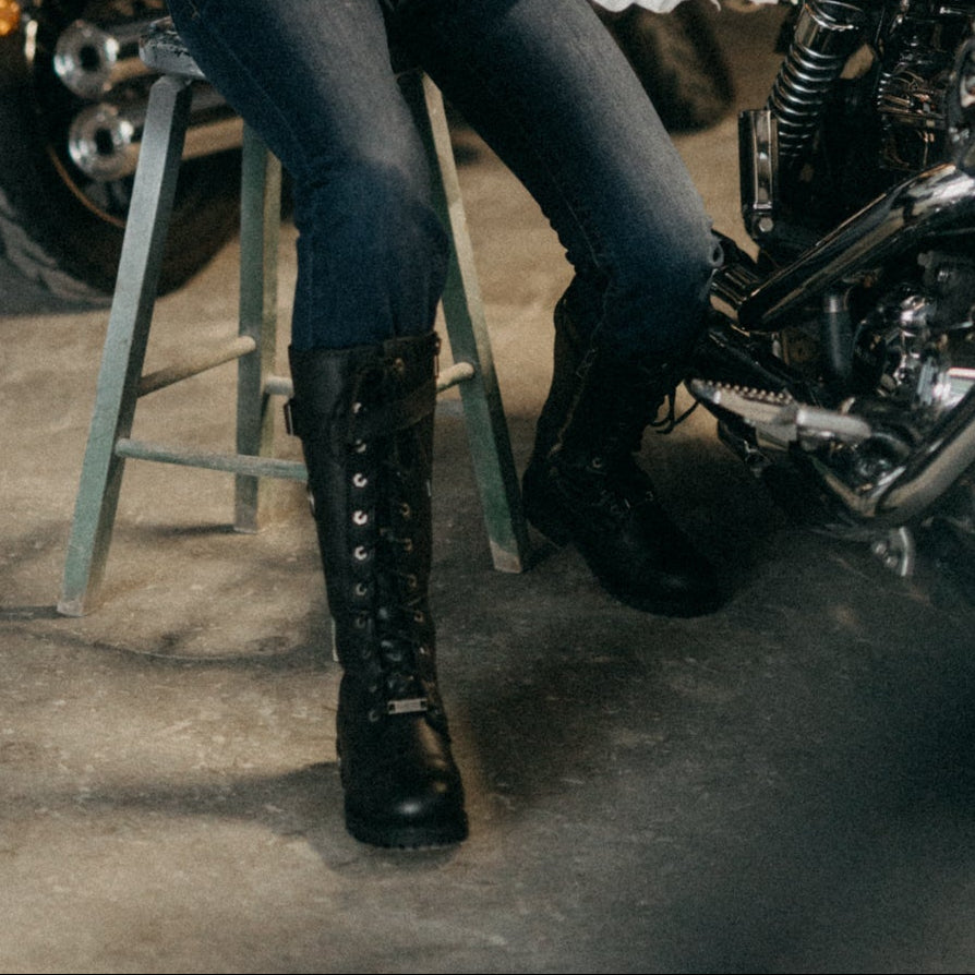 Woman sitting on a motorcycle in a garage