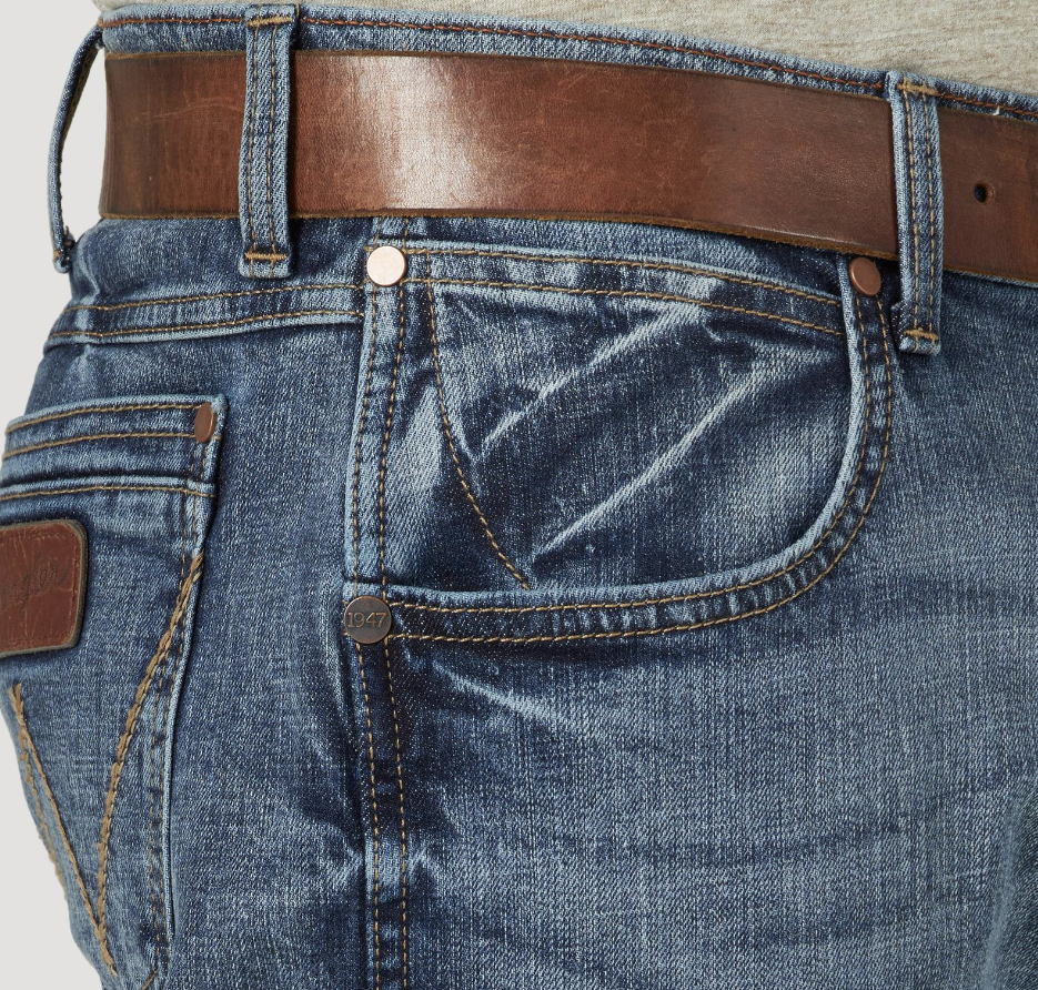 Image of Close-up of blue jeans with a brown belt on a light gray background