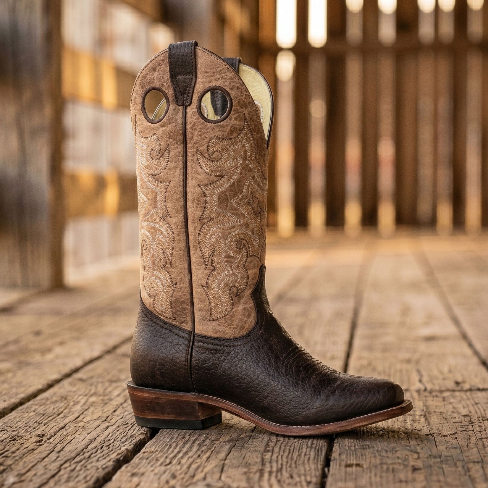 Image of Brown cowboy boot with intricate design on a wooden floor