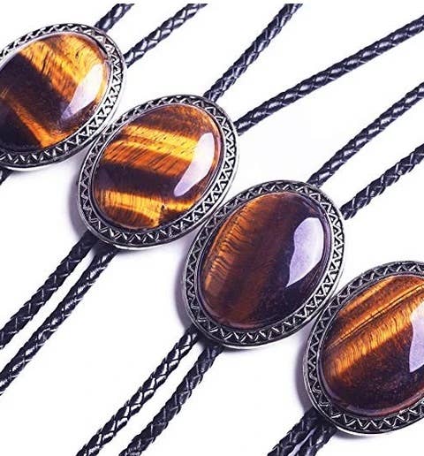 Image of Four bolo ties with tiger eye stone and metalwork on a white background